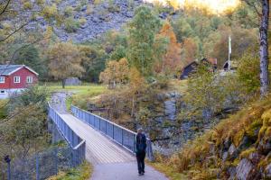 a man walking on a bridge over a hill at Sitla Hotel & Apartments in Øvre Årdal