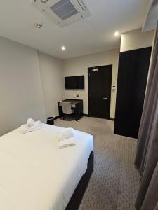 a hotel room with a bed and a desk at The Westbourne Residences in London