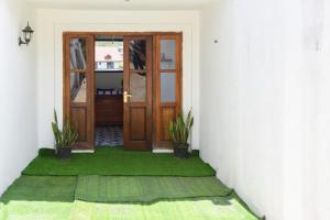 a door to a room with green grass at Shiny cot resort in Nuwara Eliya