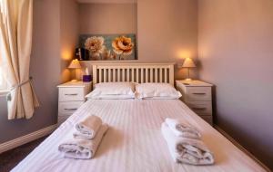 a bedroom with a bed with towels on it at The Three Coopers in Bedale