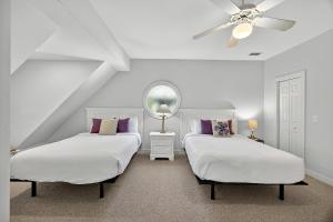 a bedroom with two beds and a ceiling fan at SM04: 4 Silver Moss in Kiawah Island +50 photos