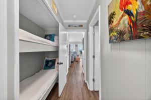 a room with two bunk beds and a hallway at SC309A: 309A Sea Cabin in Isle of Palms +33 photos