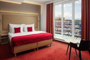 a hotel room with a bed and a large window at Astoria Hotel in Prague