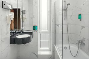 a bathroom with a sink and a shower at Astoria Hotel in Prague