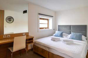 a bedroom with a bed with a desk and a mirror at Botel Marina in Prague +56 photos