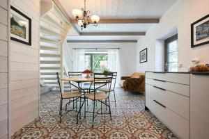 a kitchen and dining room with a table and chairs at Bottengarn Boutique Guesthouse - Farm in Igaküla