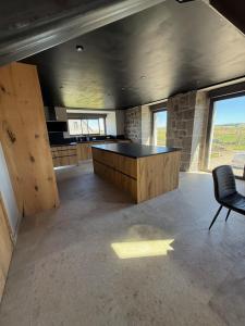a large room with a table and a chair in it at Le Ché d'Aubrac in Nasbinals +17 photos