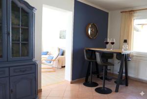 a dining room with a table with two glasses of wine at Häuschen im Grünen in Bansin