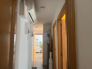 a hallway with a door to a room with a microwave at Apartment - Ampolla in L'Ampolla