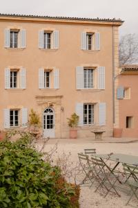 a large building with white windows and a bench at Contemporary bastide in Aix in Aix-en-Provence
