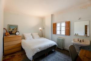 a bedroom with a bed and a sink at Contemporary bastide in Aix in Aix-en-Provence +59 photos