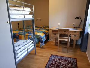 a bedroom with a bed and a desk and a bunk bed at Stockeboda Gård in Gärsnäs