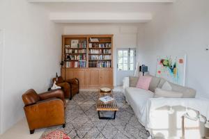 a living room with a couch and a coffee table at Contemporary bastide in Aix in Aix-en-Provence
