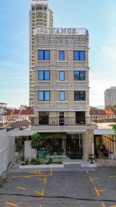 a tall building with a parking lot in front of it at Wangs Hotel Gurney Drive in George Town
