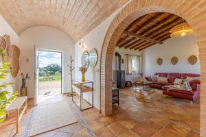 a living room with a red couch and a table at Monte do Sossego by Portugal Active in Ferreira do Alentejo