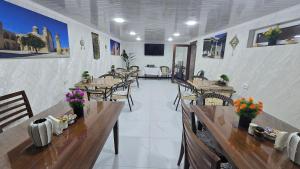 a restaurant with tables and chairs in a room at Bekhzod in Bukhara +43 photos