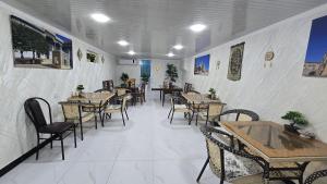 a dining room with tables and chairs in a restaurant at Bekhzod in Bukhara