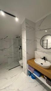 a white bathroom with a sink and a shower at Perla Petrus in Rafailovici +36 photos