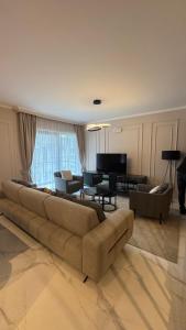a large living room with a couch and a table at Perla Petrus in Rafailovici
