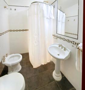 a bathroom with a toilet and a sink at Posada Shemak in Villa General Belgrano