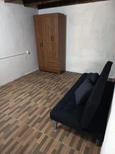 a living room with a couch and a wooden floor at Cordero Atado Hotel Apart in Ocean Park