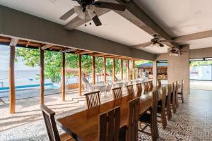 a dining room with a long table and chairs at La Patria Chica in Sampong