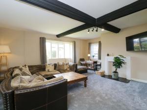 a living room with a couch and a table at 3 Woods Farm House in Chippenham