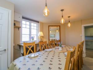 a kitchen and dining room with a table and chairs at 3 Woods Farm House in Chippenham