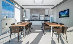 a kitchen and dining room with wooden tables and chairs at Stylish 2BR Apt in Top Location in Asunción