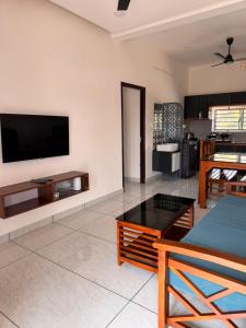 a living room with a flat screen tv on a wall at JK Homes in Alwaye