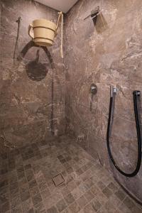 a bathroom with a shower with a bucket on the wall at Gasthof Schwabenhof in Balderschwang +38 photos