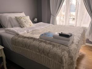 a bed with a suitcase sitting on top of it at Fruenes in Volda