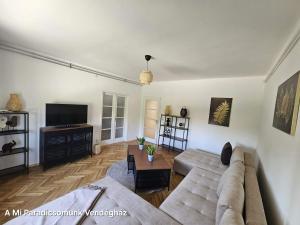 a living room with a couch and a tv at vendégház A Mi Paradicsomunk in Palotabozsok