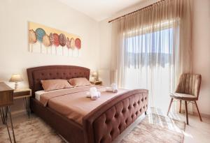 a bedroom with a large bed and a window at Philoxenia House in Sidirokastro