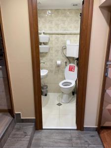 a bathroom with a toilet with a sign on the door at Къщи "И пак дойдох" in Tryavna +24 photos