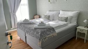 a bed with two towels on it in a bedroom at Fruenes in Volda +14 photos