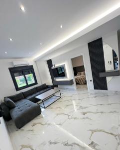 a living room with a couch and a table at Mirage Luxury Living in Nea Potidaea