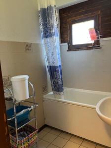 a bathroom with a sink and a shower curtain at Appartement les Carroz d'Arraches in Les Carroz d'Araches +36 photos