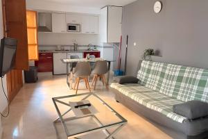 a living room with a couch and a table at Apartamentos Silleria - A 4 min de la Catedral de Granada in Granada
