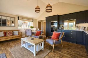 a living room with a couch and a table at Host & Stay - Mole Cottage in Swannington +14 photos