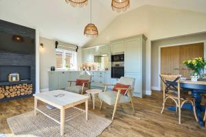 a kitchen with a table and some chairs and a table at Host & Stay - Toad Cottage in Swannington