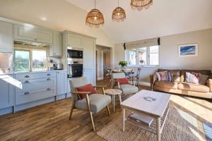 a kitchen and living room with a couch and a table at Host & Stay - Toad Cottage in Swannington +19 photos