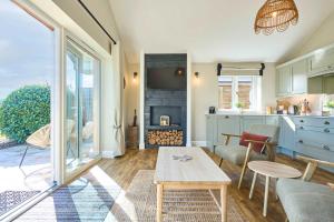a living room with a table and a fireplace at Host & Stay - Toad Cottage in Swannington