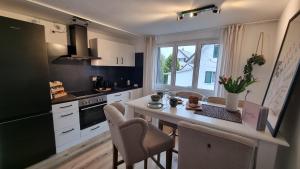 a kitchen with a table and chairs and a counter top at Eigene Wohnung I St Gallen I Appenzell I Bodensee I St Anton I Seealpsee in Rebstein