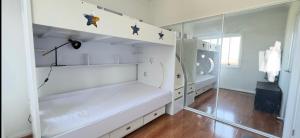 a white room with a closet with a mirror at Golf Course Frontage House in Schofields