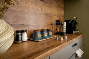 a wooden counter with four jars on top of it at וילת האושר אילת in Eilat +28 photos