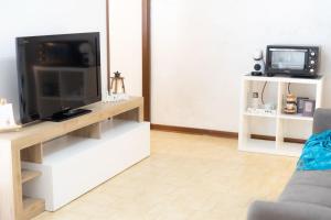a living room with a flat screen tv on a stand at a 600 m dal mare B&B MARGHERITA Silvi Marina in Silvi Marina +19 photos