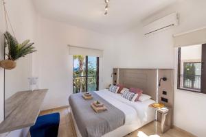 a white bedroom with a large bed and windows at Villa Mylos 7 in Protaras +131 photos
