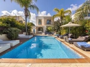 a swimming pool in front of a house at Villa Mylos 7 in Protaras
