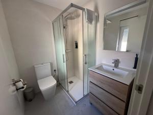 a bathroom with a shower and a toilet and a sink at Hostal Guzman El Bueno by gaiarooms in León
